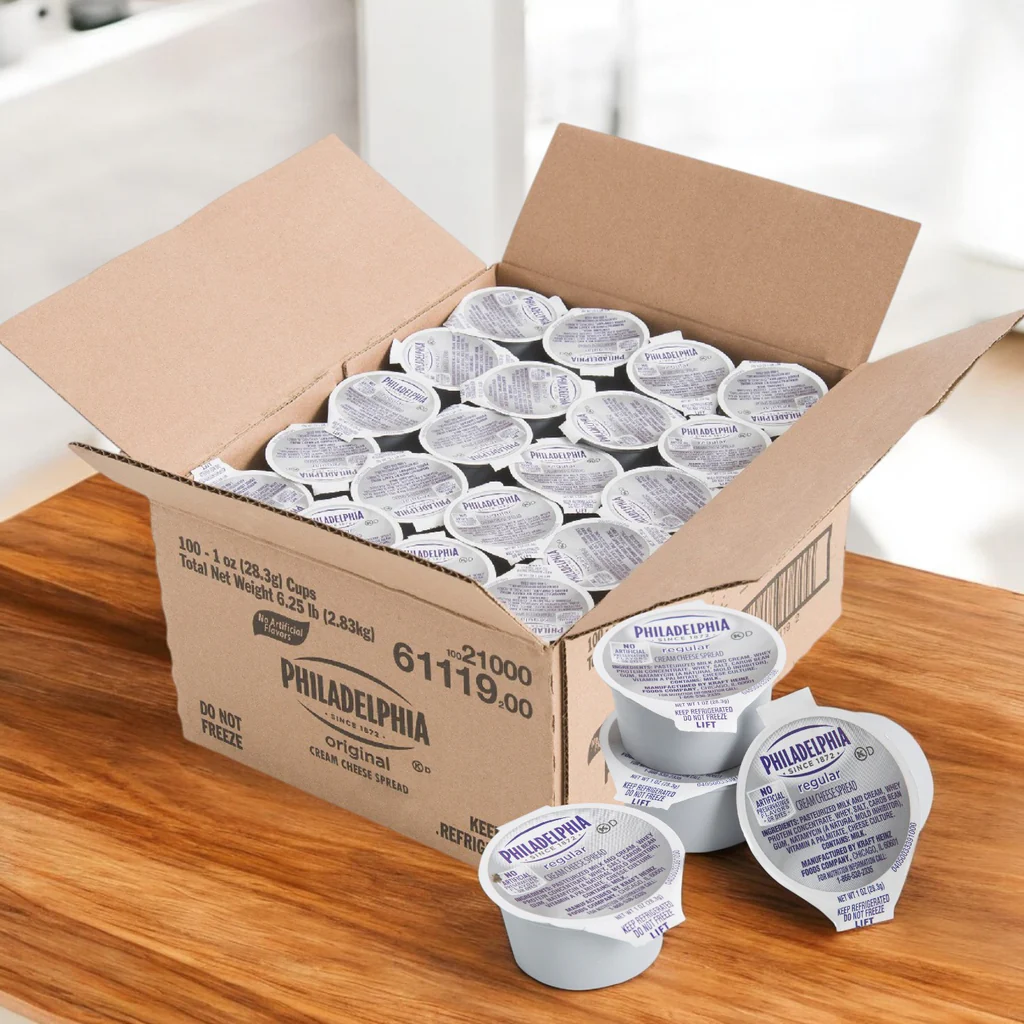 Open carton of Philadelphia cream cheese cups for foodservice, displaying 100 individual portions packaged for wholesale distribution and commercial u
